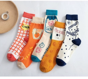 Flat lay view of colorful socks featuring diverse cartoon illustrations and graphic patterns