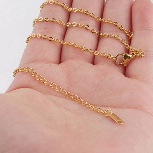 2mm gold stainless steel cable chain necklace with lobster clasp held in hand