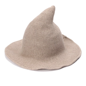 Detail of light khaki knitted witch hat featuring pointed top and wide flat brim