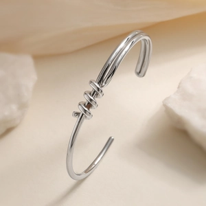 Polished silver knot cuff bracelet with elegant triple spiral design for women