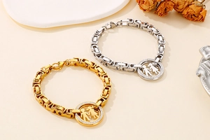 Detailed macro of gold and silver cuban link bracelets with boy and girl silhouettes