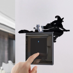 Detail of mirror acrylic Halloween witch and cat decal applied above a black light switch