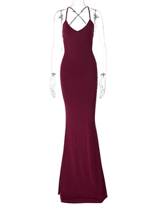 Detail of burgundy backless maxi dress with thin crisscross straps and ruched mermaid hem