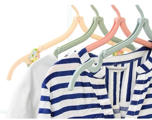 Close-up of colorful portable folding hangers supporting shirts in a bright setting