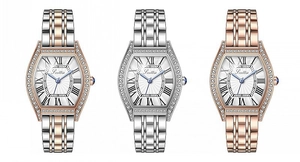 Detailed view of three luxury tonneau watches with diamond bezels and Roman numerals