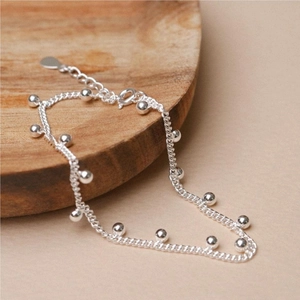 Macro detail of S925 sterling silver beaded bracelet with polished metallic balls