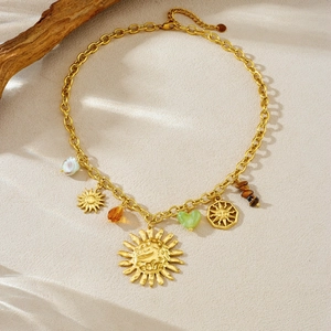 Detailed view of gold sun and heart charms on tiger eye beaded necklace with lobster clasp