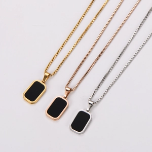 Three geometric black rectangular pendant necklaces in gold, rose gold, and silver finishes