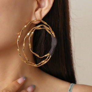Minimalist layered geometric gold twisted hoop earrings with textured metal circles