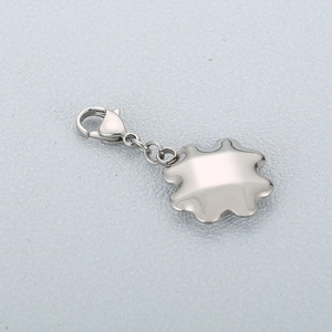 Detail of silver stainless steel flower pendant with lobster clasp on grey background