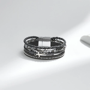 Detail of multilayer PU leather bracelet with gray beads, rhinestones and a cross charm