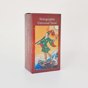 Macro detail of deep red Holographic Universal Tarot box with the Fool illustration