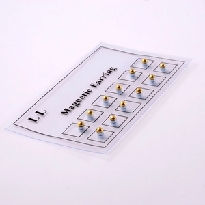 Detail view of 12 pairs of golden magnetic non-piercing studs on a display card