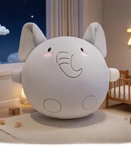 Close-up of soft plush elephant doll with cute embroidered nose in cozy nursery setting