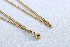 Detailed macro view of a gold layered necklace chain with a lobster clasp closure
