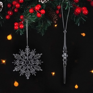 Macro view of crystal acrylic snowflake and icicle pendants on Christmas pine branches
