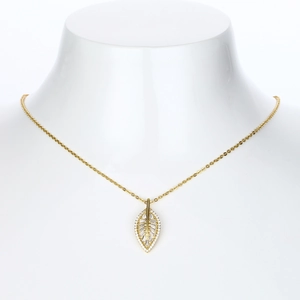 Macro view of gold leaf pendant with white zircons on a delicate cable chain
