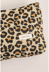 Close-up of leopard print woven jacquard fabric with a rectangular H&R BAG logo tag