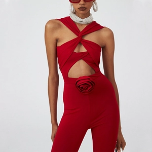 Red cutout jumpsuit with 3D floral accent and halter neck for a slim fit appearance