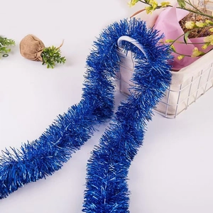 Detail of fluffy 2m blue metallic tinsel garland for festive wedding and Christmas decor