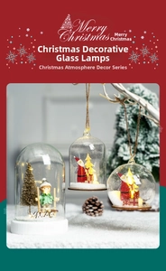 Close-up of lighted Christmas glass lanterns with Santa and LED tree festive decor