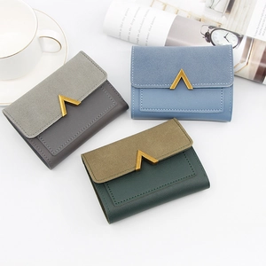Three minimalist short tri-fold leather wallets in grey, blue, and green with V-shaped metal deco