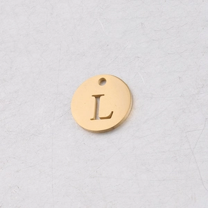 Vue macro d'un pendentif rond doré de 12mm en acier inoxydable avec la lettre L évidée