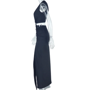 Detail view of the sleek waist cutout and side ruching on a black sleeveless maxi dress