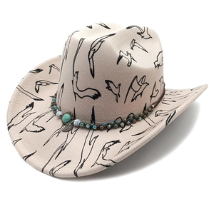 Detail of felt cowboy hat with bird print, turquoise beads and metal leaf pendant
