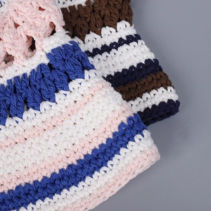 Close-up of handmade crochet knit bucket hat with colorful striped texture pattern