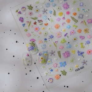 3D floral nail art stickers with pastel embossed sunflowers and wildflowers on a clear sheet