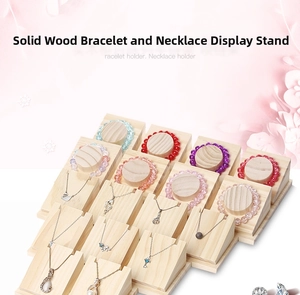 Macro view of multi-unit solid wood jewelry display stands for necklaces and bracelets