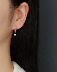 Close-up of S925 sterling silver geometric star hoop earring with pavé zircon accents