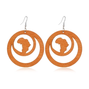 Detail of wooden round earrings with hollow African map and crescent moon design