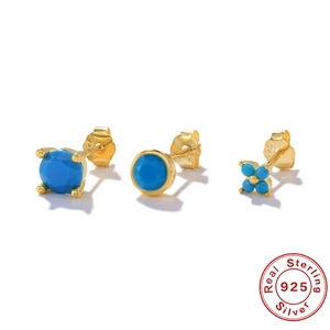 Macro view of sterling silver gold-plated earring set featuring turquoise gemstones