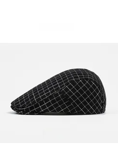 Side view of newsboy cap showing detailed black and white plaid pattern and fabric texture