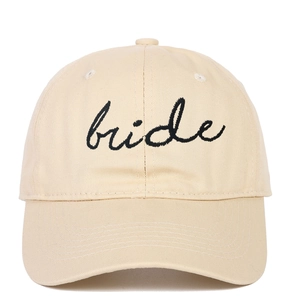 Detail of elegant black bride script embroidery on a beige cotton baseball hat
