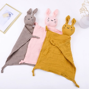 Three soft cotton gauze baby security blankets with rabbit heads in brown, pink, and yellow