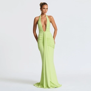 Detailed back view of a light green halter neck gown with backless tie and fishtail hem