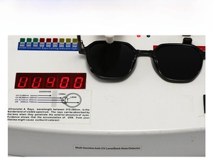 Close-up of polarized sunglasses on a UV400 test device showing ultraviolet protection