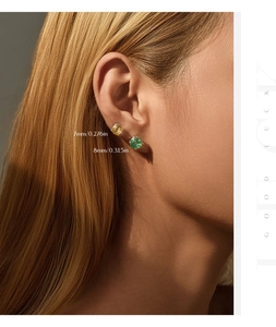 Macro shot of 7mm champagne and 8mm green gemstone studs with dimensions on model