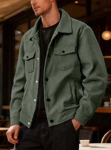 Detailed view of dark green corduroy jacket with classic lapel and double chest pockets