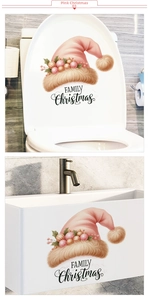 Autocollant de bonnet de Noël rose et lettrage sur le couvercle des toilettes