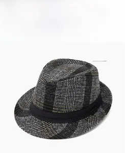 Detail view of the gray plaid fedora hat with a black ribbon band and wool texture