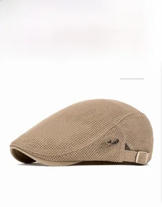 Close-up of khaki mesh flat cap featuring side letter branding and adjustable back strap