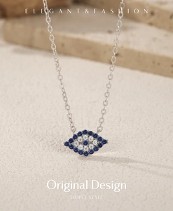 Macro shot of silver evil eye necklace with pave blue and white crystals on stone
