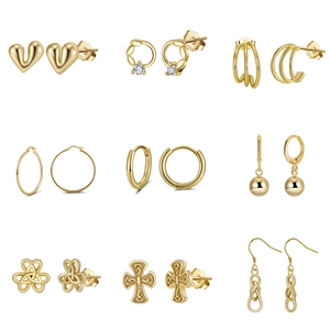 Collection of nine gold S925 sterling silver earrings featuring hearts and hoops