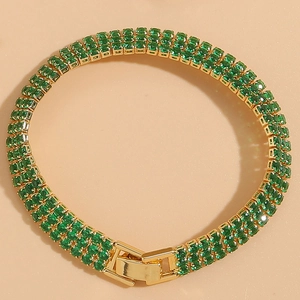 Detailed close-up of triple-row green zircon bracelet with 14K gold plated claw setting