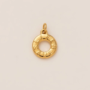 Macro detail of golden 18K gold plated lifesaver pendant with engraved lettering