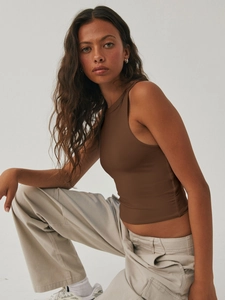 Detail of brown Y2K sleeveless cropped tank top paired with beige cargo pants